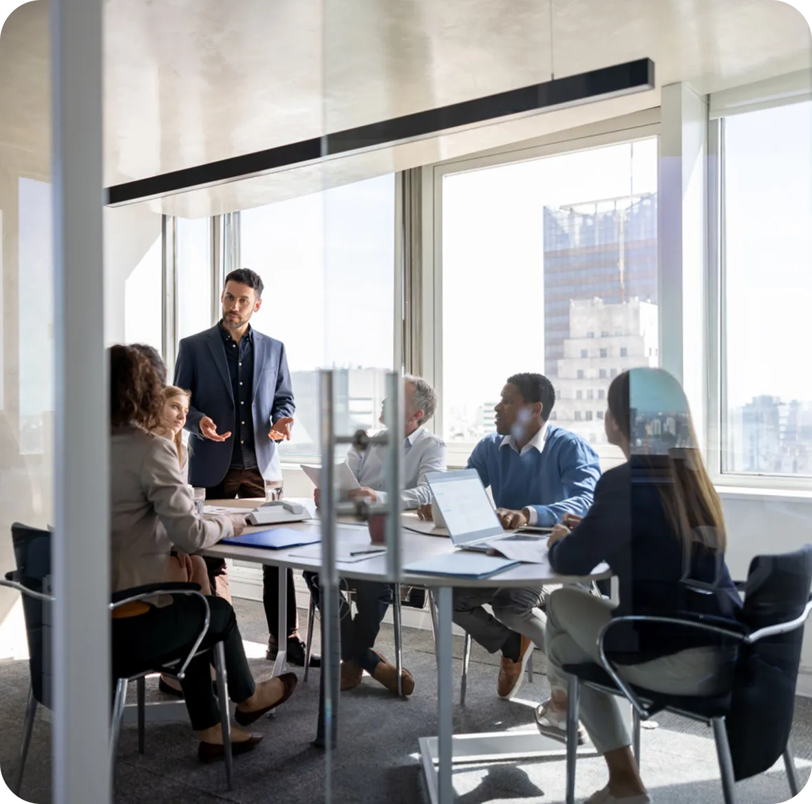 Colleagues collaborating in bright meeting room